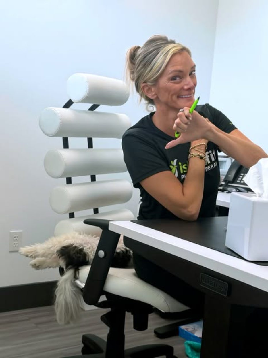 An IslandFit clinician smiling at the front desk