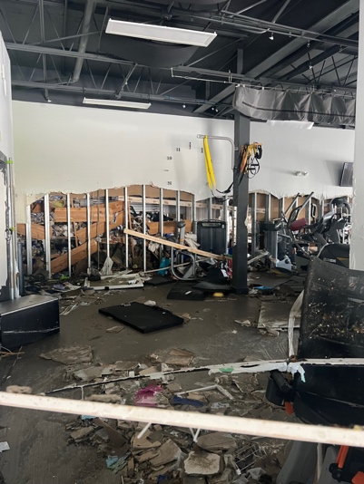 Exercise equipment and stripped walls inside the flooded clinic